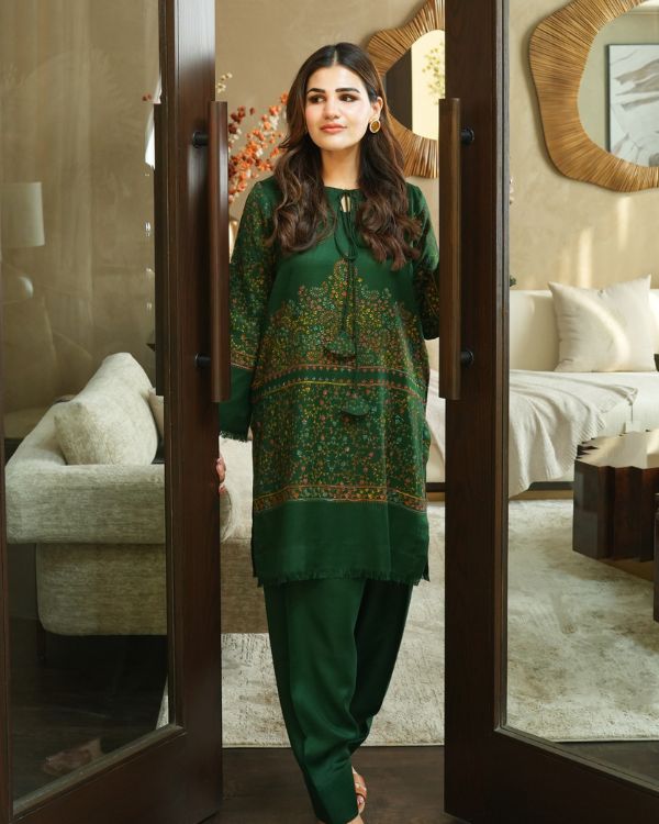 NYRA A story stitched in green—luxurious pashmina, delicate hand embroidery, and effortless charm. This shirt and shalwar set is designed for women who love subtle luxury and refined tradition.